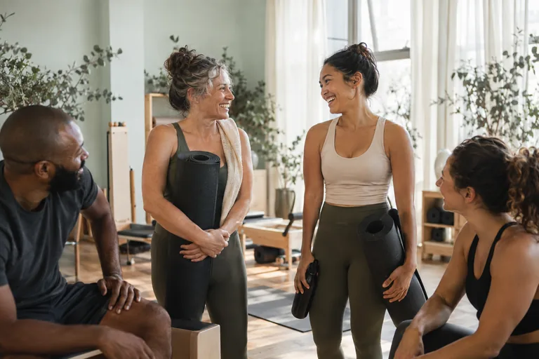 Participants sharing a conversation after a group studio class
